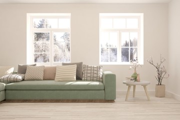 Modern living room in white color with sofa and winter landscape in window. Scandinavian interior design. 3D illustration
