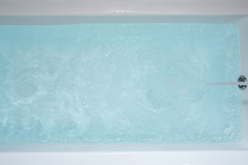 Blue water in the bath. Bathroom. Top view.