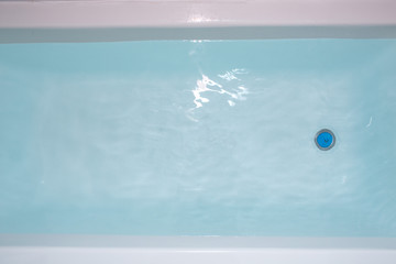 Blue water in the bath. Bathroom. Top view.