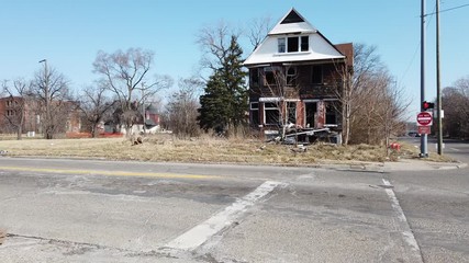 Left To Right  Pan Of Poor Depressed Housing In Ghetto Neighbourhood Red Brick House With Grafitti In Detroit Michigan