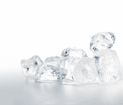 Group of natural crystal clear melting ice cubes on white background.