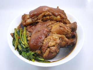 Thai food style, Top view of stewed pork leg with  kale in white bowl isolated on white background, This food is most popular, Ka moo is Thai traditional, Ready to eat or serve