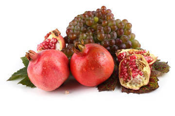 Pomegranate and grape isolated on white