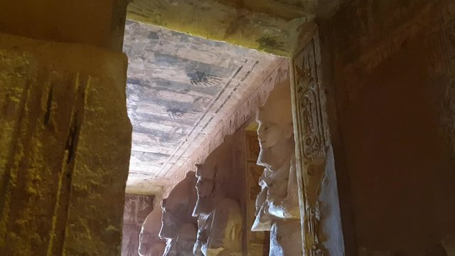 Pharaoh statue columns in row with sun light come in at Abu Simbel Egypt