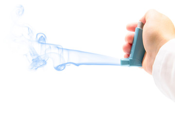 hand with an asthma inhaler on a white background