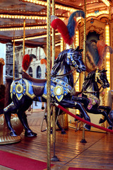 Fototapeta na wymiar Traditional classic French styled vintage colorful horse carousel in the town square