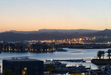 Landscape photograph of the suburb of Ayla in Aqaba in Jordan and the Gulf of Aqaba at nightfall