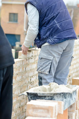 masons working on a construction site close up