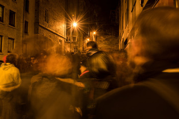 An ghostly abstract street scene of the Hogmanay procession in Edinburgh, Scotland, of people...