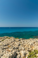Fototapeta na wymiar CYPRUS, NISSI BEACH - MAY 12/2018: Tourists swim on catamarans and kayaks in the popular bay of the Mediterranean Sea.