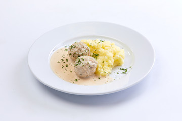 meatballs with mashed potato on the white plate
