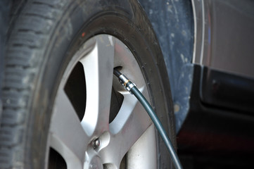 Fototapeta premium Pump air into a tire