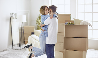 Happy smiling young couple showing a pair of keys of their new house