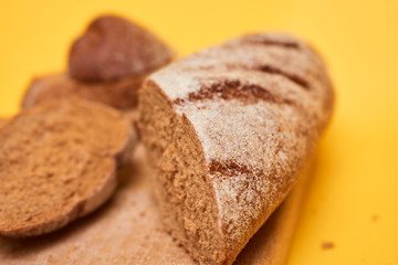 Bread on cut board. Fresh bread on the kitchen table. The healthy eating and traditional bakery concept.