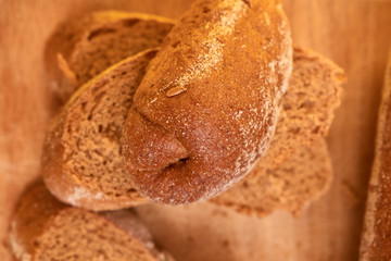 Bread on cut board. Fresh bread on the kitchen table. The healthy eating and traditional bakery concept.