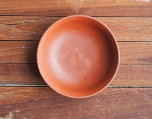 Blank empty red brick bowl on wooden background