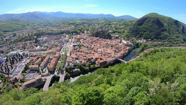 Skyline Aerial View of the Tiny French Village of Foix, France Nestled in a Valley Along a River During a Hiking Along The Mountain Edge on A Beautiful Blue Sky Spring Day