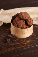 Chocolate cookies with cranberries on a wooden background
