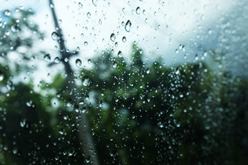 Dew and Raindrops on a window glass in natural rainforest