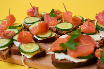 Sandwiches with red fish. Sandwiches with trout or salmon, butter and cucumber.