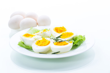 boiled eggs with salad leaves in a plate