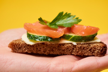 Sandwiches with red fish. Sandwiches with trout or salmon, butter and cucumber.