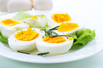 boiled eggs with salad leaves in a plate