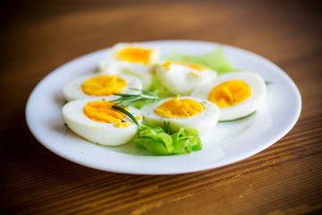 boiled eggs with salad leaves in a plate