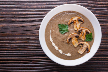 mushroom cream soup on rustic wooden background