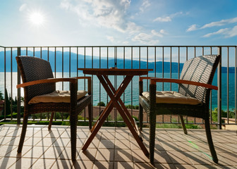 Fototapeta premium Terrace with table and chairs with view in Garda Lake in Gargnano in Italy
