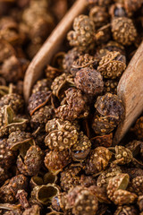 fragrant Sichuan pepper on white acrylic background