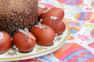 Easter cake and decorated chicken eggs laid out on a plate. Easter tradition: chicken eggs are...
