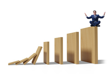 Businessman in domino effect concept