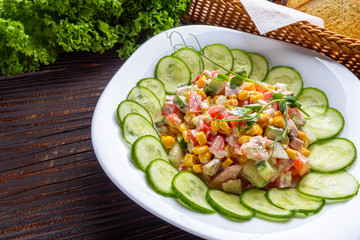 Fresh salad of vegetables and meat on wooden rustic background