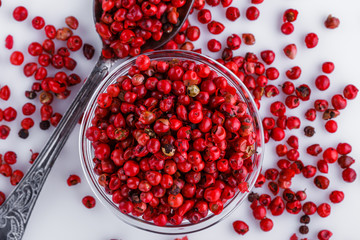 fragrant pink peppercorns on white acrylic background