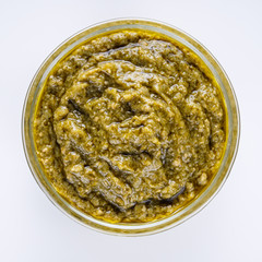 Delicious traditional Italian pesto sauce on a white background