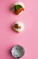 Colorful delicious ice cream on a pink background, with spices, mint leaves.