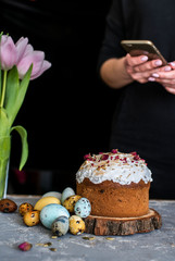 Easter composition with sweet bread, kulich and eggs on light background.