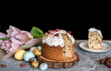 Easter composition with sweet bread, kulich and eggs on light background.