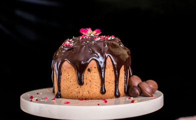 Easter composition with sweet bread, kulich and eggs on light background.