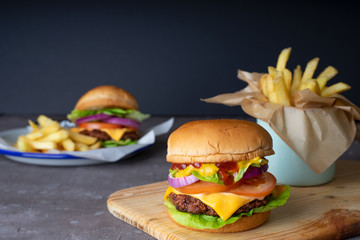Homemade burger serve with french fries with black background