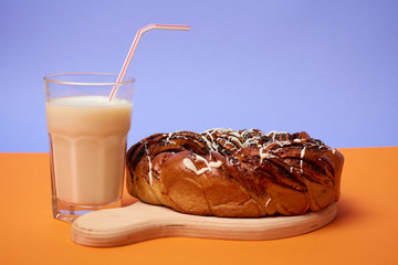 Braided roll with poppy seeds and cinnamon on yellow background. Top view