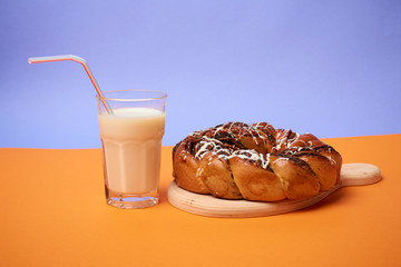 Braided roll with poppy seeds and cinnamon on yellow background. Top view