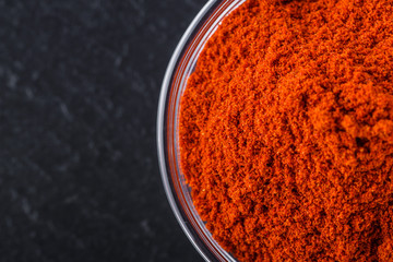 aromatic ground paprika on a dark stone background
