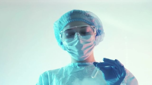 Immunogen synthesis. Biotechnology innovation. Female technician testing drugs in ampoule.