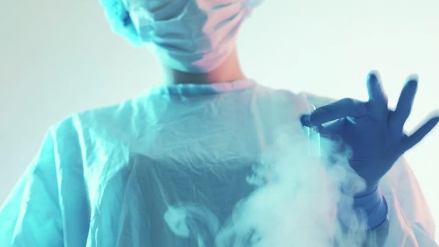 Vaccine development. Pharmaceutical science. Female technician testing drugs in ampoule.