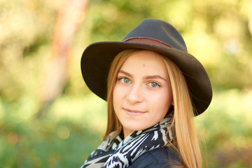 Beautiful young woman is walking in the park. Young woman enjoying nature