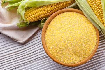 Polenta corn porridge on white wooden rustic background