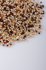 mix of quinoa grains on white acrylic background