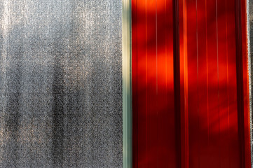 Close up red aluminium metal roof sheet with polyethylene foam background